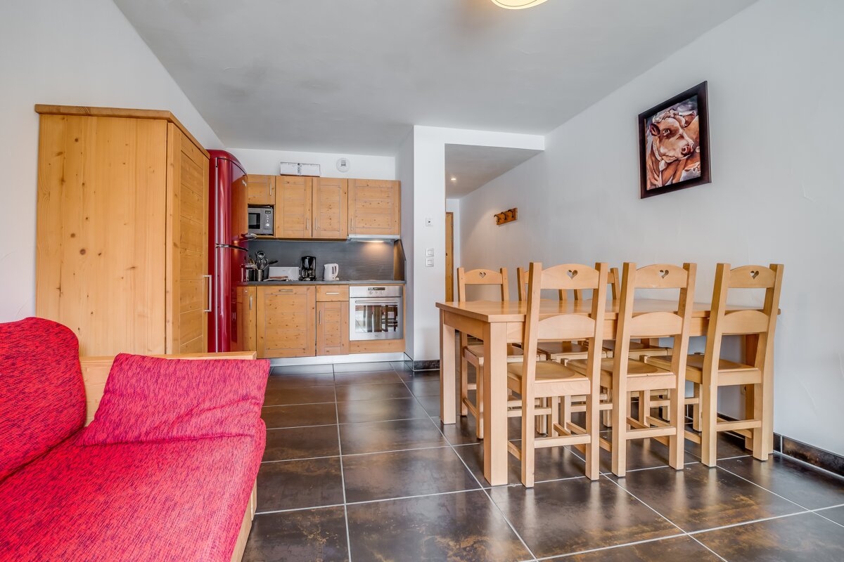 A picture of a cow hangs above a dining table