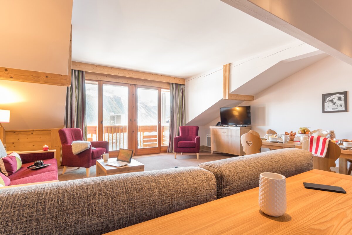 A living room with a couch and two chairs