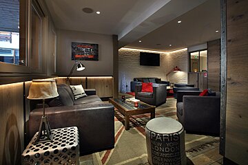 A living room with a stool that says paris on it