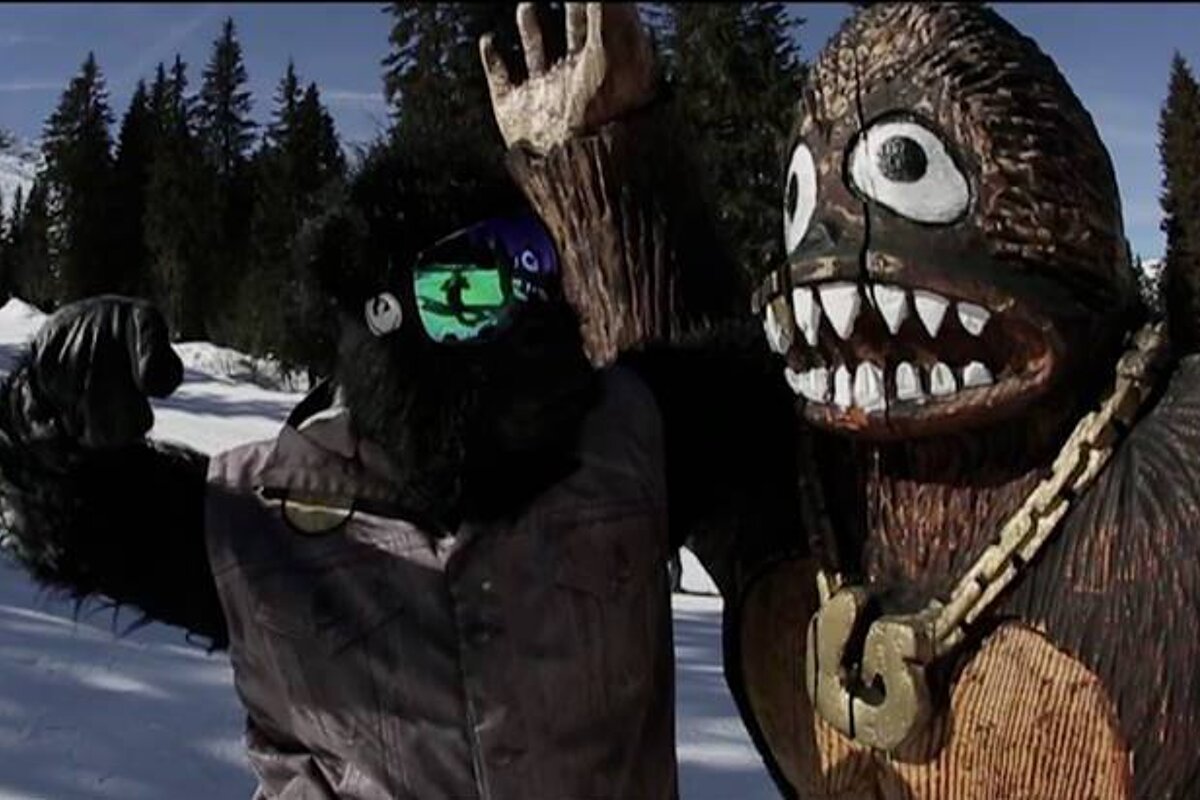 a man in goggles going to punch shreddie in teh snow park