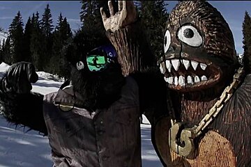 a man in goggles going to punch shreddie in teh snow park