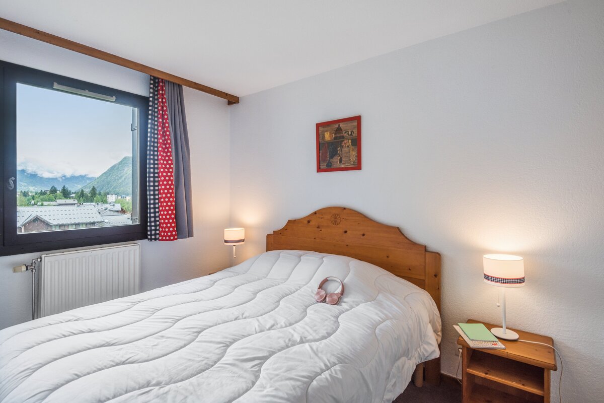 A bedroom with a bed and a picture on the wall