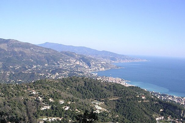 A view of a valley with mountains and a body of water