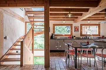 A wooden staircase leads up to the second floor of a house