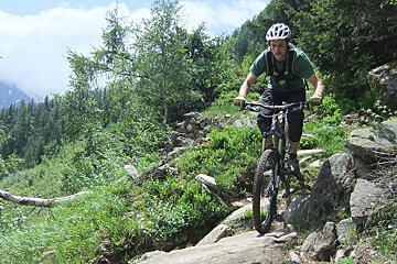 a mountain biker riding a technical trail in chamonix
