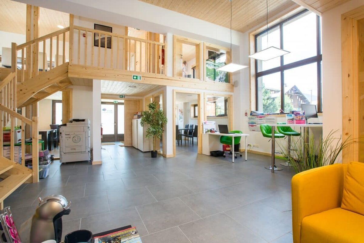 A room with a green exit sign on the ceiling