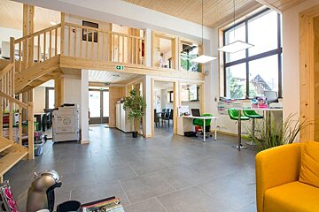 A room with a green exit sign on the ceiling