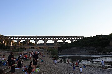 the river and children playing at the pont du gard in provence
