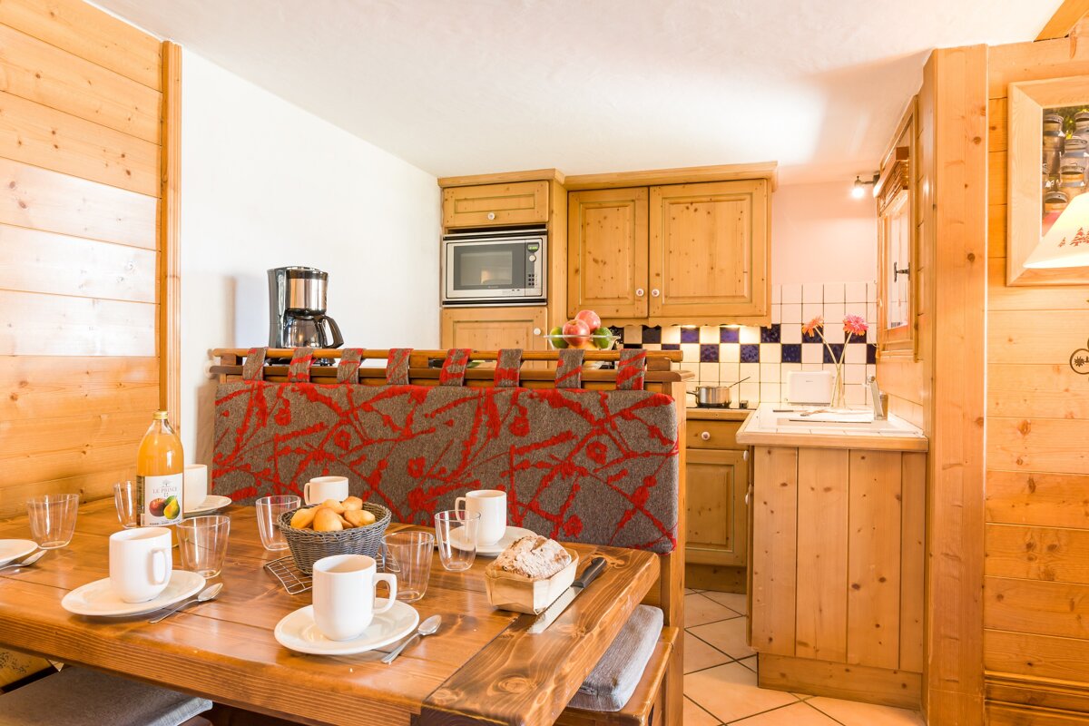 A kitchen with wooden cabinets and a coffee maker