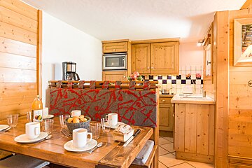 A kitchen with wooden cabinets and a coffee maker