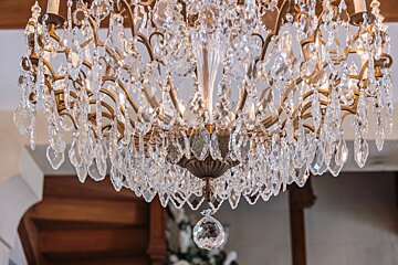 A chandelier with lots of crystals hanging from the ceiling