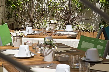A wooden table with plates and cups on it