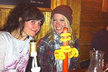 a wooden stand with onion rings on it