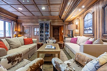 A living room filled with furniture and a coffee table with a book on it