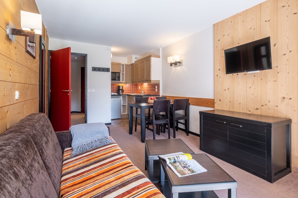 A living room with a couch and a flat screen tv