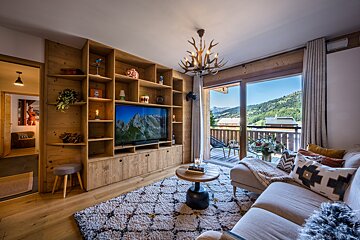 A living room with a couch and a flat screen tv