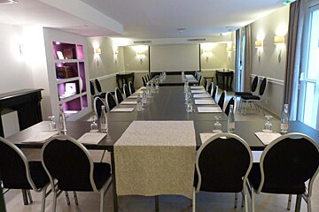 A conference room with a long table and chairs