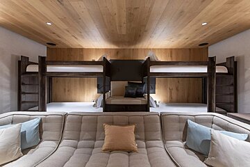 A living room with bunk beds and a couch