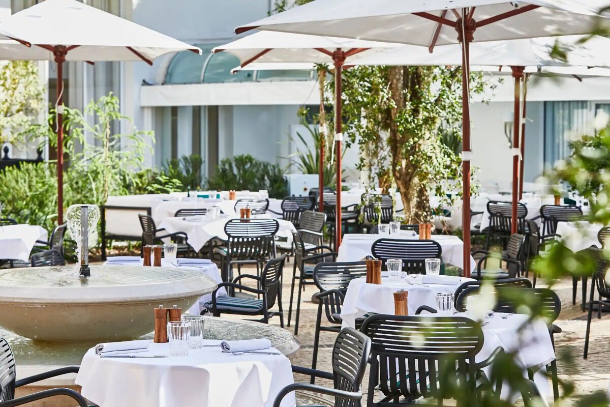 A restaurant with tables and chairs and umbrellas