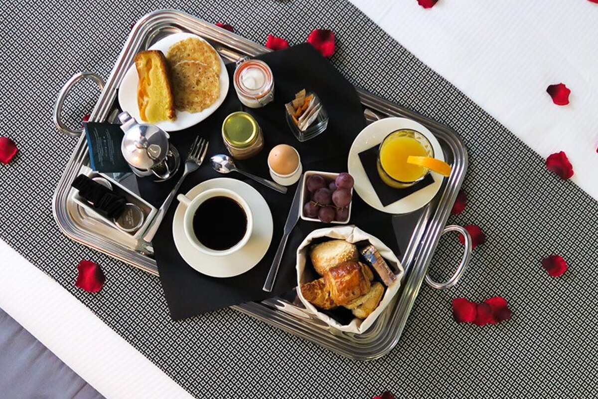 A silver tray with a cup of coffee on it