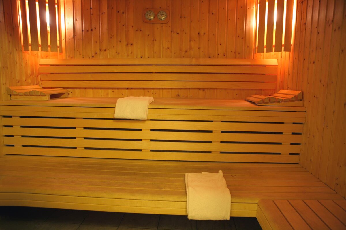 A wooden sauna with two clocks on the wall