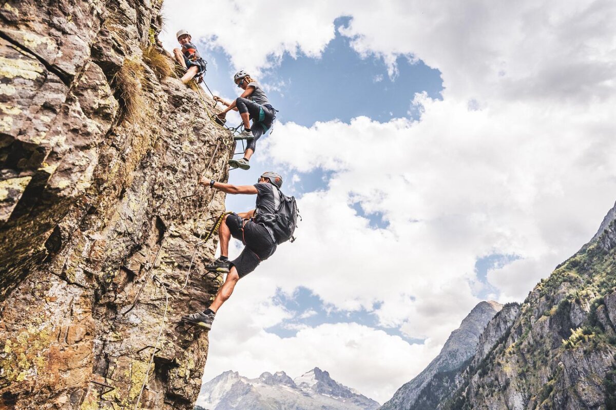 A family climbing a via ferrata in Les Deux Alpes
