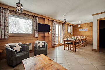A living room with a chair with a cross on it