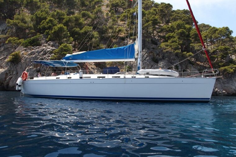 A sailboat with a blue sail is floating in the water