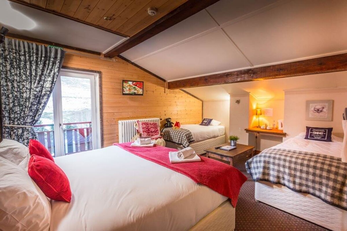 A bedroom with two beds and a picture on the wall that says ski