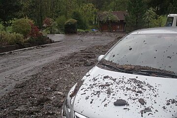 a car covered in mudslide debris near Morzine