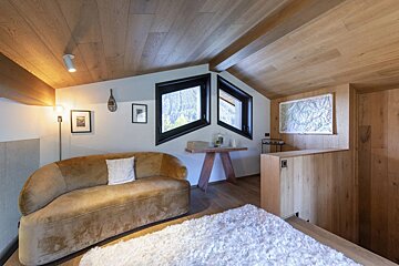 A living room with a couch and a map on the wall