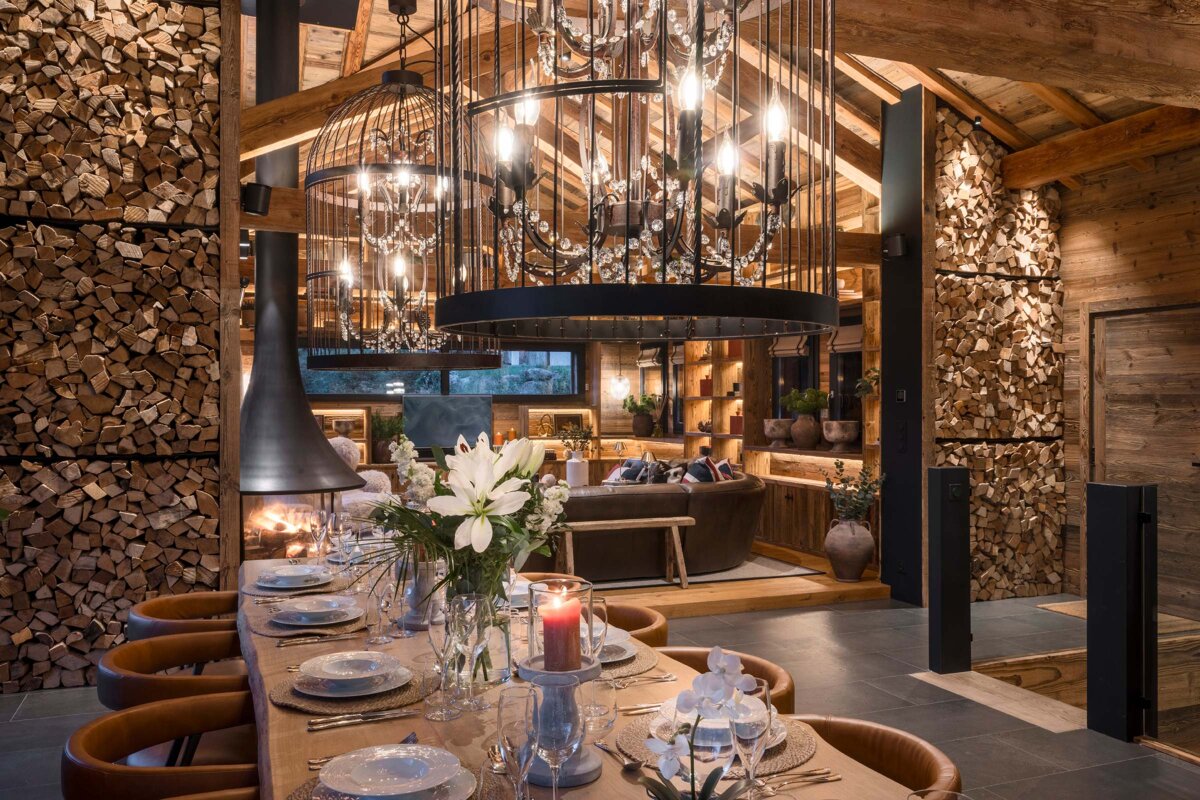 A dining room table with plates and candles on it