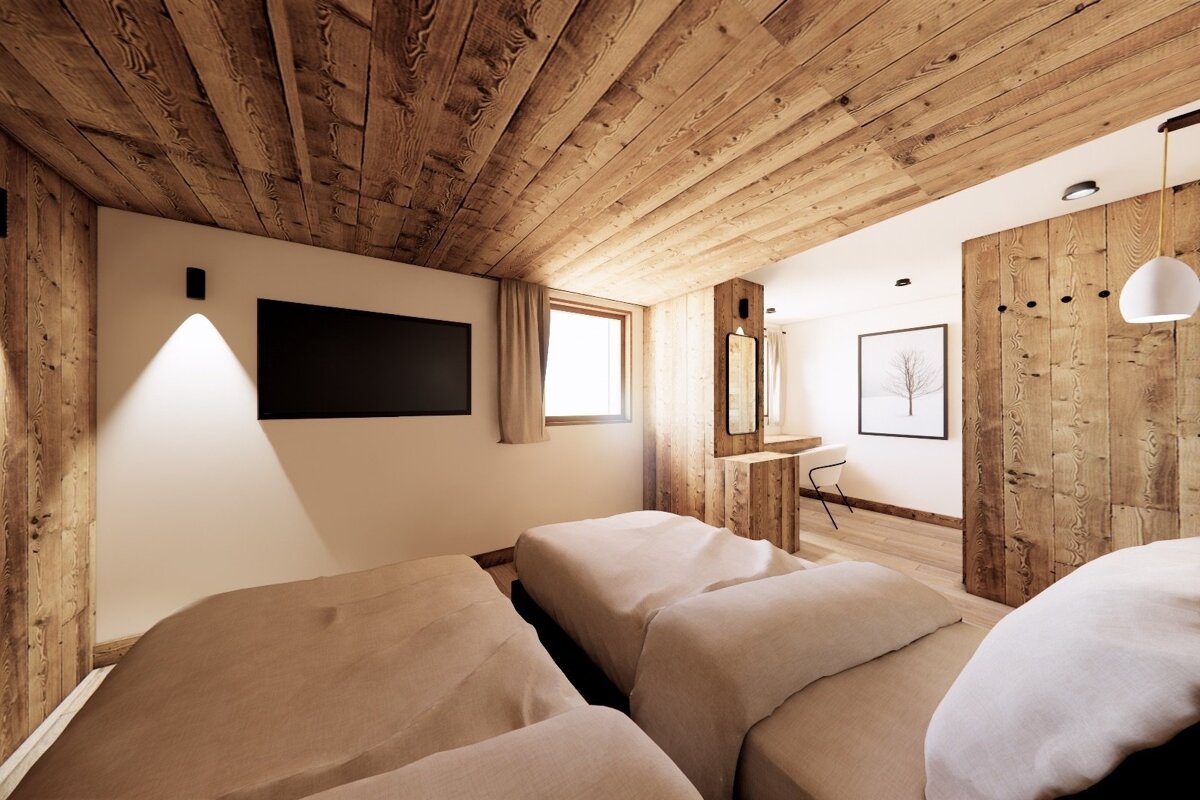 A cozy, rustic bedroom featuring natural wood plank ceilings/walls, two beds, a wall TV, window, and a vanity nook with a mirror. Warm ambiance.