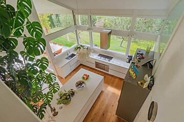 An aerial view of a kitchen with a large island in the middle