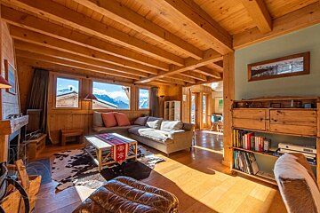 A living room with a couch and a bookshelf