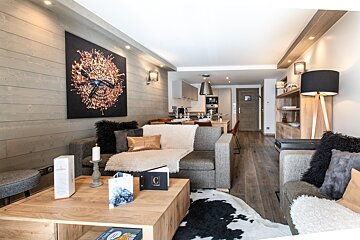A living room with a couch a chair and a coffee table