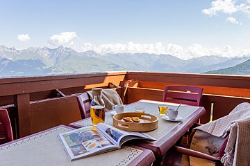 A table with a magazine and a tray of food on it