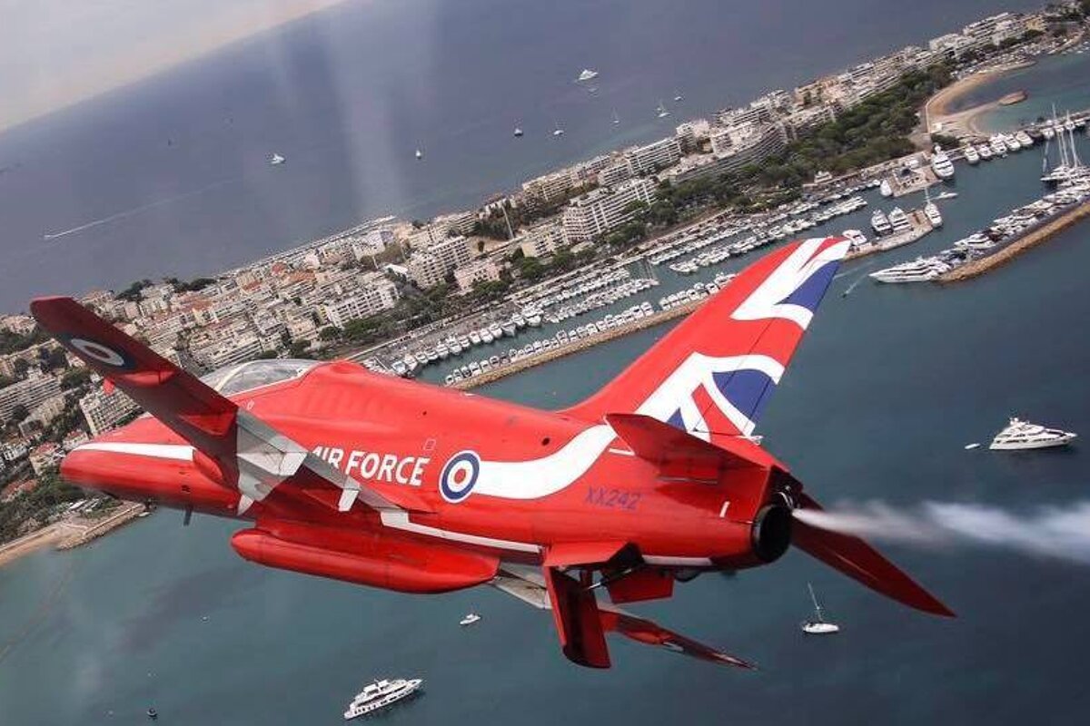 RAF red arrow jet flying above cannes