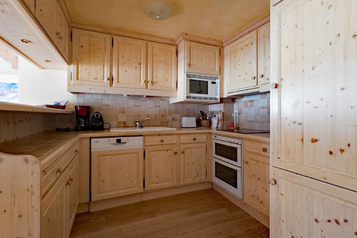 A kitchen with wooden cabinets and a siemens dishwasher