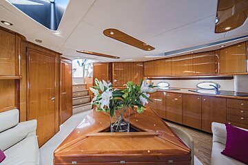 A kitchen with a vase of flowers on the counter