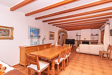 A living room with a wooden table and chairs