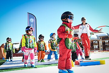 A group of children wearing purple action bibs