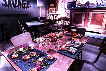 A restaurant with the word savage on the wall