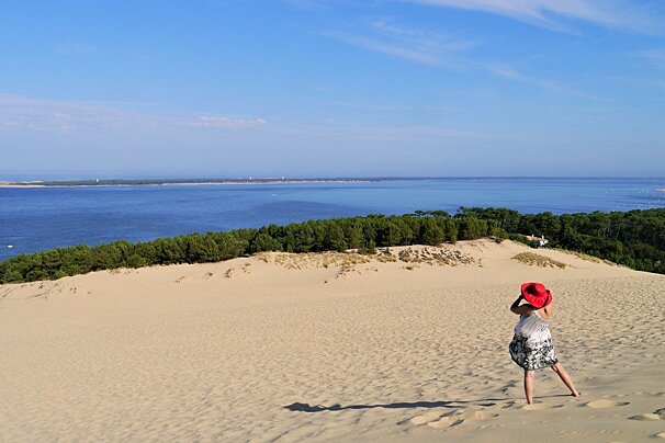 a woman in red hat on dune du pilat