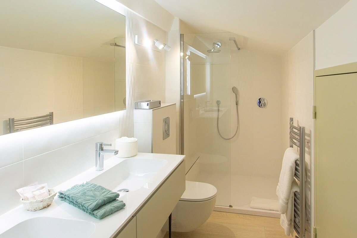 A bathroom with a toilet a sink and a shower