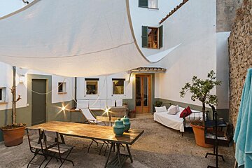 A patio with a table and chairs under a canopy
