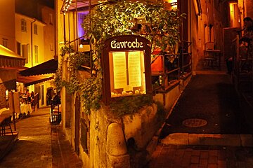 image of lanes at night with a restaurant sign