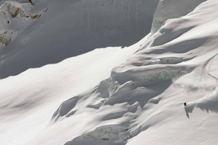 a snowboarder skiing off piste