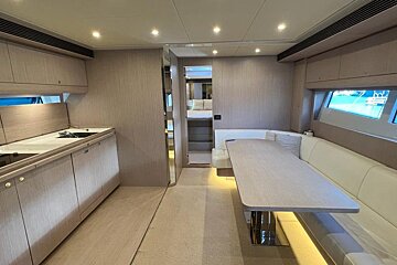 A kitchen and dining area on a boat with a table
