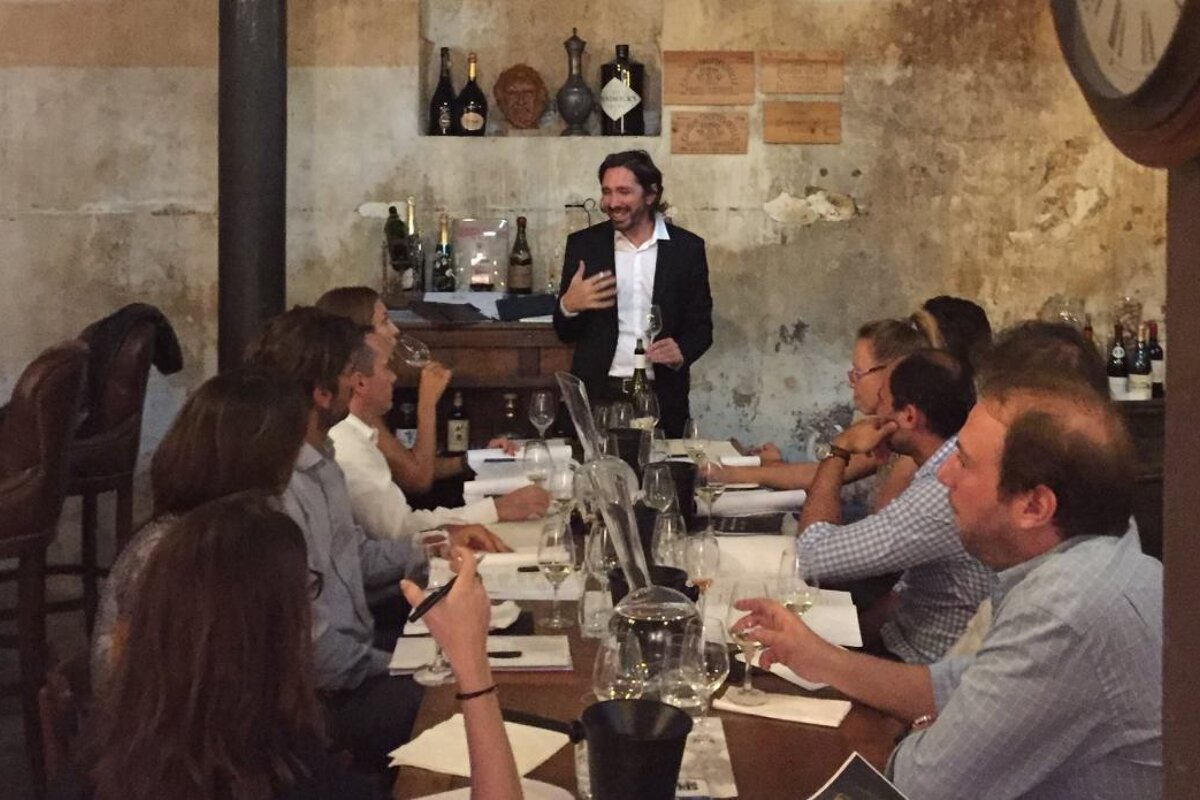 people sitting round a table at a wine tasting in Monaco